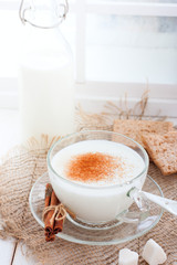 Homemade kefir in a glass cup with cinnamon and sugar, selective focus