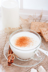 Homemade kefir in a glass cup with cinnamon and sugar, selective focus