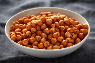Roasted spicy chickpeas in white bowl. Healthy food