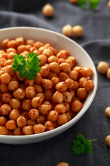 Roasted spicy chickpeas in white bowl. Healthy food