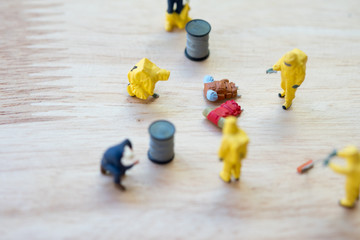 Miniature crime scene investigator with backpack on ground