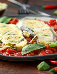 Grilled aubergine, eggplant topped with parmesan cheese crust on crashed tomatoes. Vegetarian pizza version