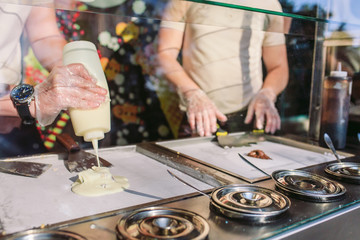Obraz na płótnie Canvas stir-fried ice cream rolls at freeze pan. Organic, natural rolled ice cream, hand made dessert.
