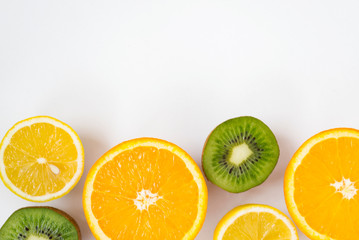 Colorful fresh fruits on white background. Orange, mandarin, kiwi, lemon. Fruit background. Summer food concept.