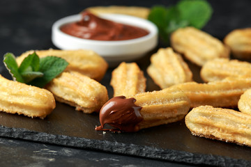 Churros with chocolate dipping sauce. sugar and cinnamon.