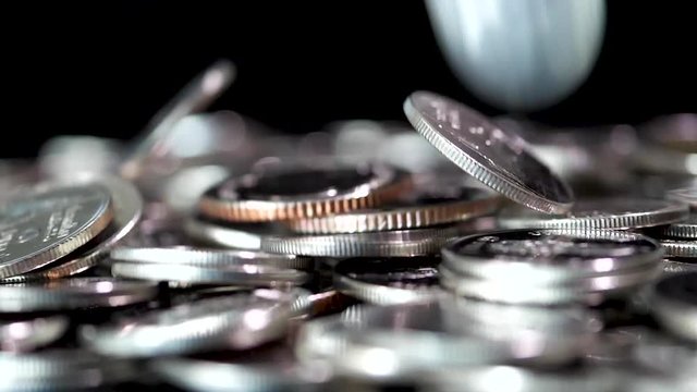 Slow motion close up falling coin on black background (Thai currency, THB coin)