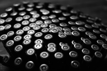 Bullets on wooden background.