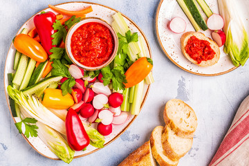 Plate with fresh, raw vegetables and sauce.
