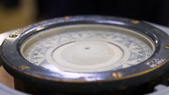 Close up of a vintage magnetic compass on board a sailing vessel