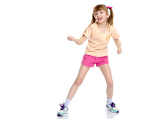 A little girl shows her muscles.