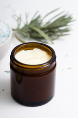 shea butter in brown glass pot and lavender leaves