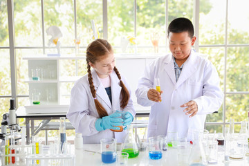 Fototapeta premium two happy kids making science experiments. (education and scientist concept)