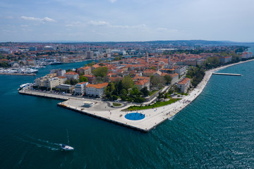 Obraz premium Widok na miasto Zadar. Czas letni w regionie Dalmacji w Chorwacji. Linia brzegowa i turkusowa woda i błękitne niebo z chmurami. Zdjęcie wykonane dronem z góry.