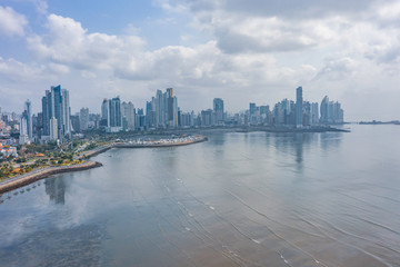 Scenic aerial view of downtown of capital of Panama. Beautiful cloudy look of skyscrapers on coastline of Pacific ocean in Panama-City. Shot of hightech megapolis in small country in Caribbean sea 