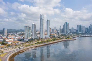 Fototapeta na wymiar Scenic aerial view of downtown of capital of Panama. Beautiful cloudy look of skyscrapers on coastline of Pacific ocean in Panama-City. Shot of hightech megapolis in small country in Caribbean sea 