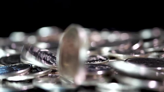 Slow motion close up falling coin on black background (Thai currency, THB coin)
