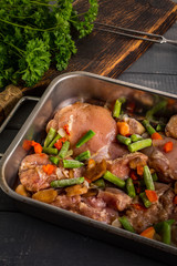 Prepared for baking chicken meat with vegetables.