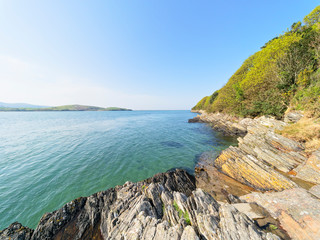 The rocky shoreline of the River Dwyryd on a bright spring day.