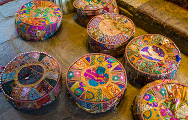 colorful meditation pillows on the floor, seats in a spiritual center