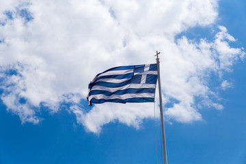 greek flag waving on blue sky clouds greece