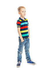 Standing boy in full growth in jeans and a bright T-shirt. Vertical. Isolated on a white background.