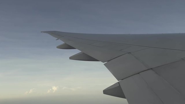 plane wing flying in the sky, view of shadow outside plane window
