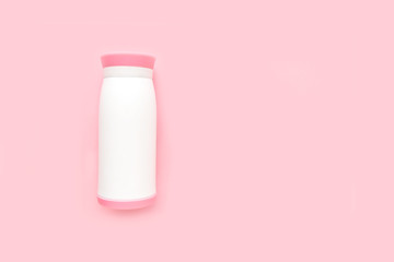 Water bottle on a pink background, minimalism, flat lay top view.
