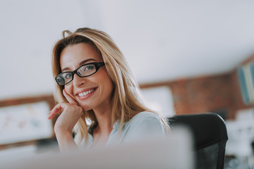 Pretty woman in glasses posing and touching her cheek