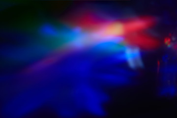 Blurry spots of light in green, blue, white and red
