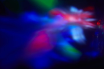 Obraz na płótnie Canvas Multicolored blurred spots of light on a dark background.