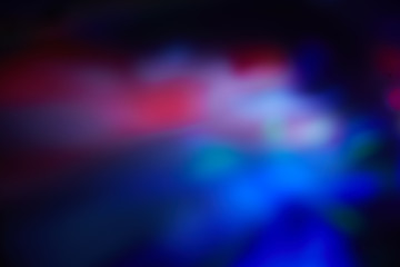 Blurry spots of light in green, blue, white and red