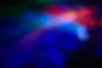 Blurry spots of light in green, blue, white and red