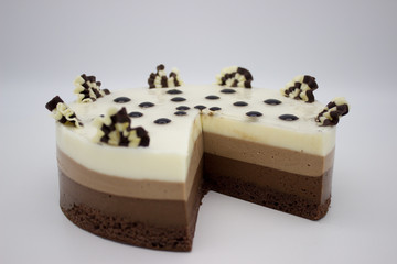 Chocolate cake. Cake of several varieties of chocolate: black, milk and white. On a white background