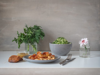 Breakfast of fried chicken breast and cabbage salad on a white table