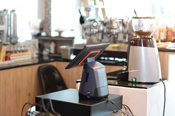 casher machine with blurred coffee shop counter background