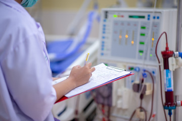 The specialist are checking continuous renal replacement therapy equipment and injection pump and...