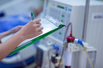 The specialist are checking continuous renal replacement therapy equipment and injection pump and...
