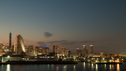 Fototapeta na wymiar Yokohama Building and Port with many ships at sunset in Japan Winter; Photo view from Osan bridge