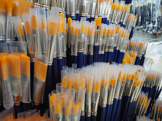 Yellow and blue brushes for painting in the art shop