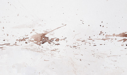 abstract brown splashes on white watercolor paper.