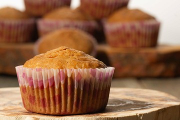 homemade muffins with coconut chips on a wooden stand