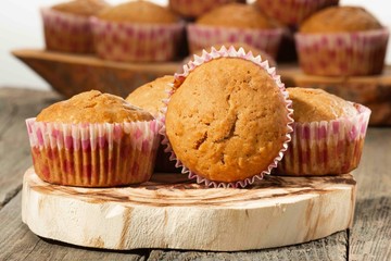 homemade muffins with coconut chips on a wooden stand