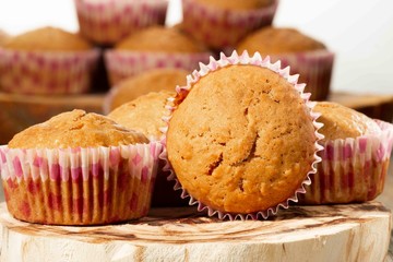 homemade muffins with coconut chips on a wooden stand