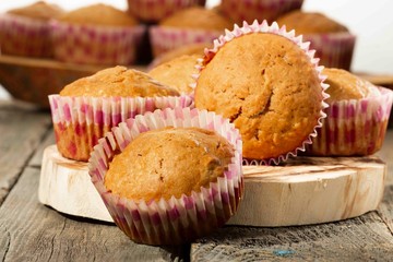 homemade muffins with coconut chips on a wooden stand