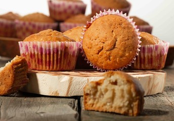 homemade muffins with coconut chips on a wooden stand