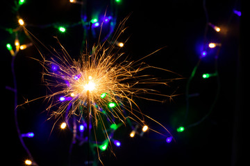 sparkler with blur new year's light close up