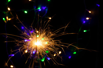 sparkler with blur new year's light close up