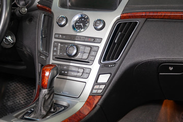 View to the black color interior of suv car with front seats, steering wheel and dashboard  with gray leather upholstery after cleaning and detailing in vehicle repair workshop. Auto service industry.