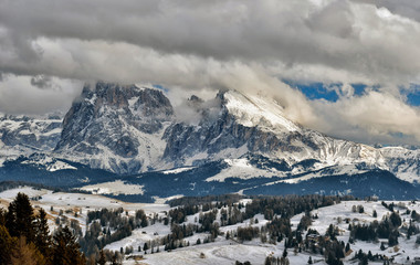 Fototapeta na wymiar Winter panorama of italian ski resort with background of Seiser Alm, Alpe di Siusi, a high altitude alpine meadow in Dolomites with Langkofel and Plattkofel mountains under snow, South Tyrol, Italy.