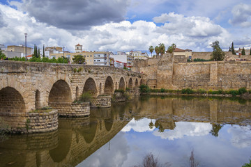 Obraz premium View of the Roman bridge of Merida with its reflection on the Guadiana river. Merida. Spain.The Archaeological Ensemble of Merida is declared a UNESCO World Heritage Site Ref 664